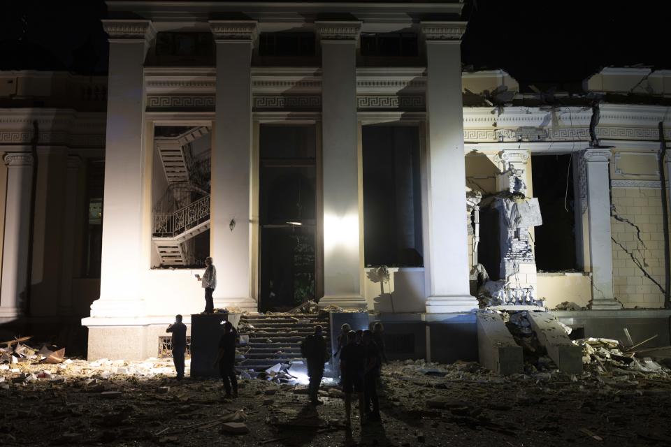 Emergency workers gather outside the Odesa Transfiguration Cathedral, heavily damaged in Russian missile attacks in Odesa, Ukraine, Sunday, July 23, 2023. (AP Photo/Jae C. Hong)