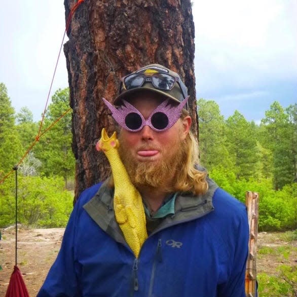 Ian O'Brien is pictured with the rubber chicken that was his frequent travel companion.