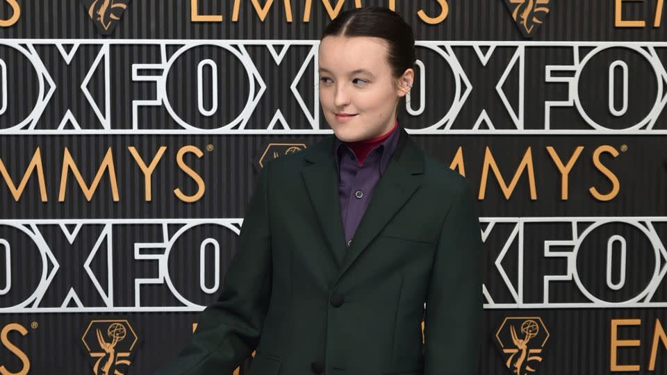 “Last of Us” star Bella Ramsey once again impressed in a suit, looking dapper in a dark green Prada two-piece with a purple shirt and hot pink turtleneck. - Richard Shotwell/Invision/AP