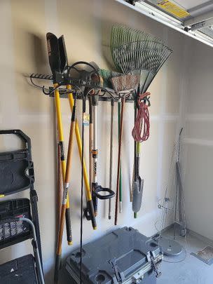 A solid steel garden tool wall mount