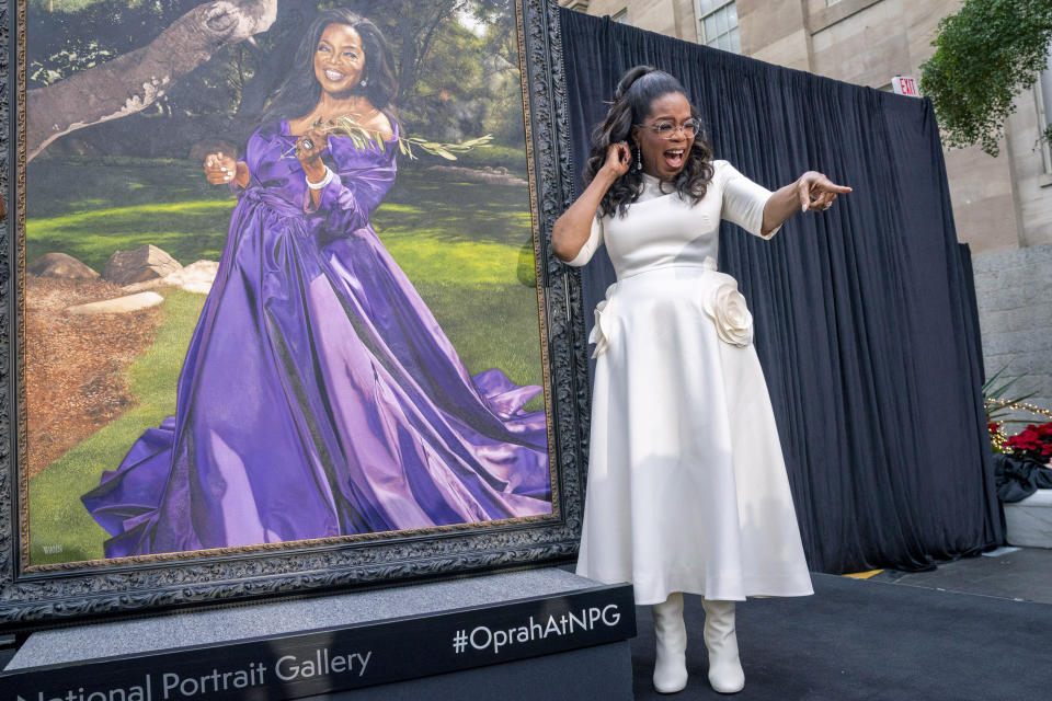 Oprah Winfrey shouts out to a member of the crowd while next to her portrait, Wednesday, Dec. 13, 2023, during a portrait unveiling ceremony at the Smithsonian's National Portrait Gallery in Washington. (AP Photo/Jacquelyn Martin)