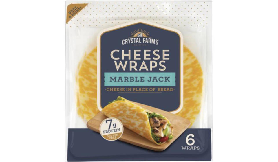 Package of Crystal Farms Cheese Wraps in marble jack variety, shown on the packaging being used as a faux sandwich wrap.