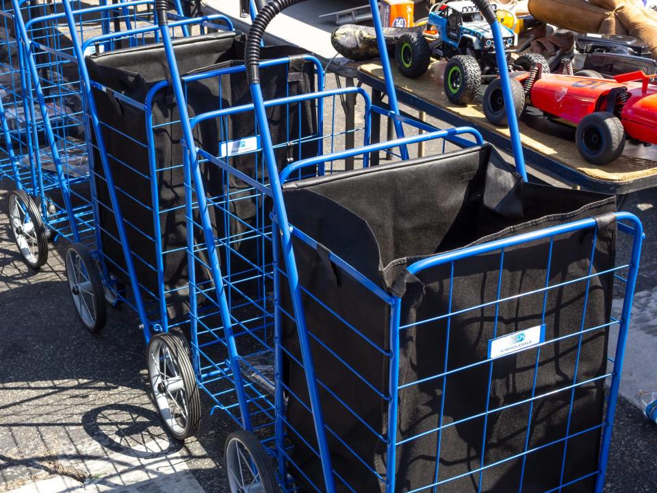 Foldable shopping carts with black bags inside them.