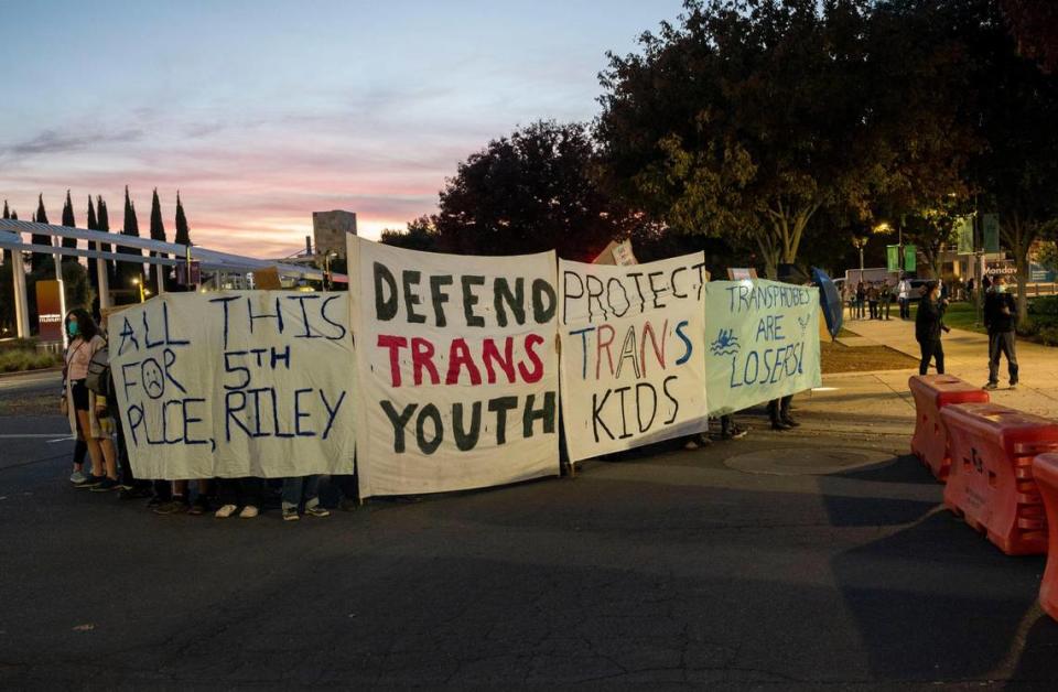 A group of protesters defending trans youth gather outside the conference centers at UC Davis as controversial speaker Riley Gaines, known for her outspoken views against trans-women in sports, prepares to speak Friday, Nov. 3, 2023, during her Speak Louder Campus Tour.