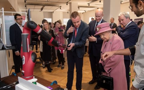 The Queen is shown a robot arm - Credit: Paul Grover