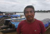 Eduardo Kanamari from the Kanamari ethnic group stands on a pier on the Atalaia do Norte river shore, in Amazonas state, Brazil, Sunday, June 12, 2022. Federal Police and military forces are carrying out searches and investigations into the disappearance of British journalist Dom Phillips and Indigenous affairs expert Bruno Araujo Pereira in the Javari Valley Indigenous territory, a remote area of the Amazon rainforest in Atalaia do Norte, Amazonas state. (AP Photo/Edmar Barros)