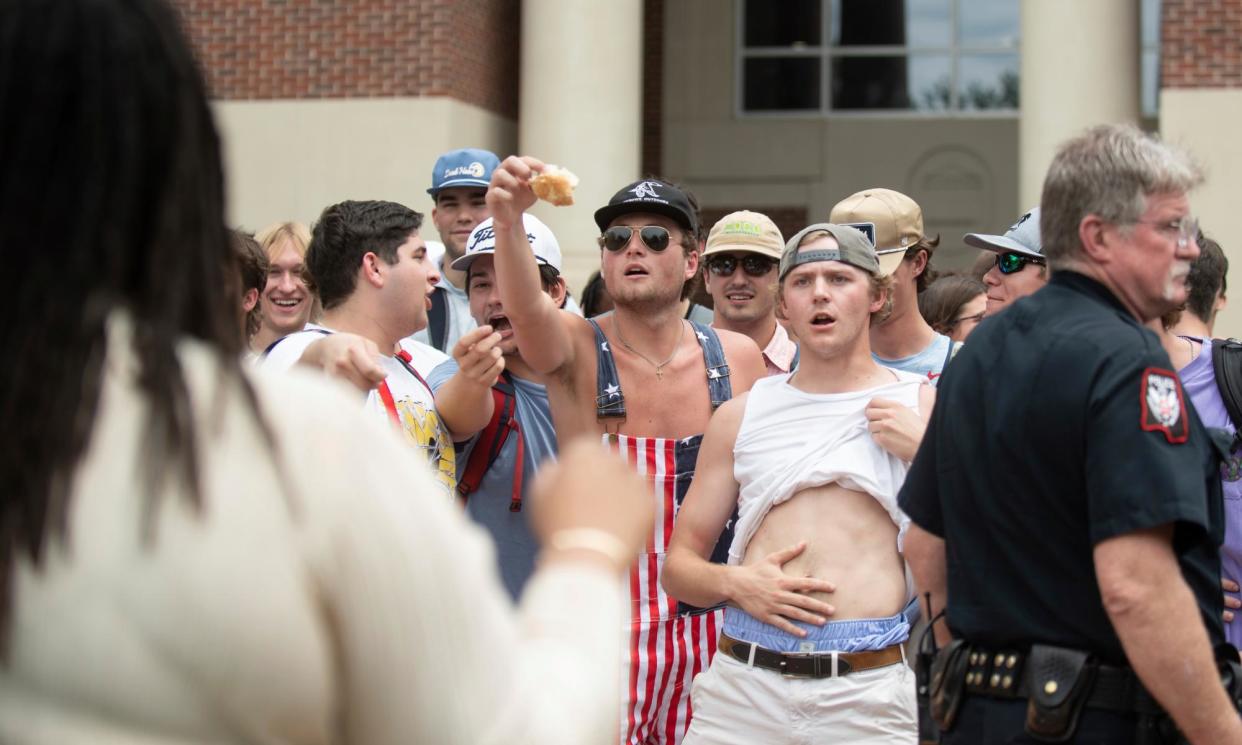 <span>University of Mississippi counter-protesters taunt pro-Palestinian protesters on Thursday in Oxford, Mississippi.</span><span>Photograph: HG Biggs/AP</span>