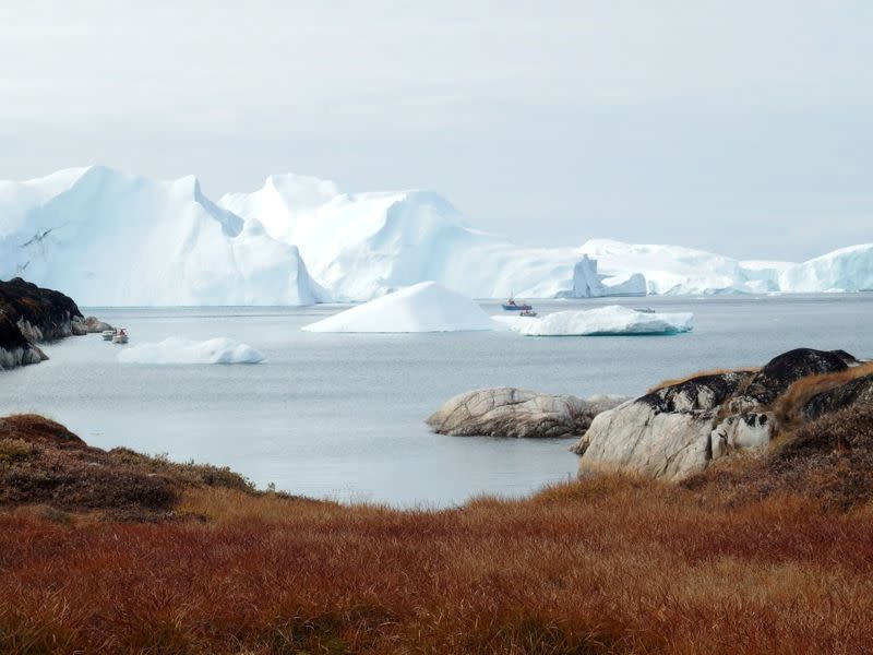 FILE PHOTO: Fishing vessels are seen next to the icebergs near Ilulissat