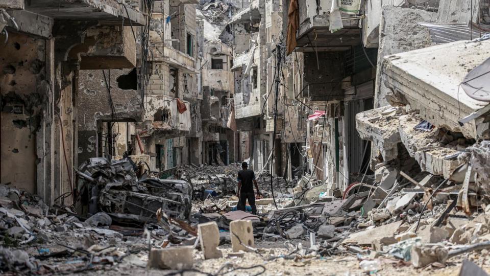 PHOTO: A Palestinian man walks on building rubble in Khan Yunis in the southern Gaza Strip, Apr. 22, 2024. (AFP via Getty Images)