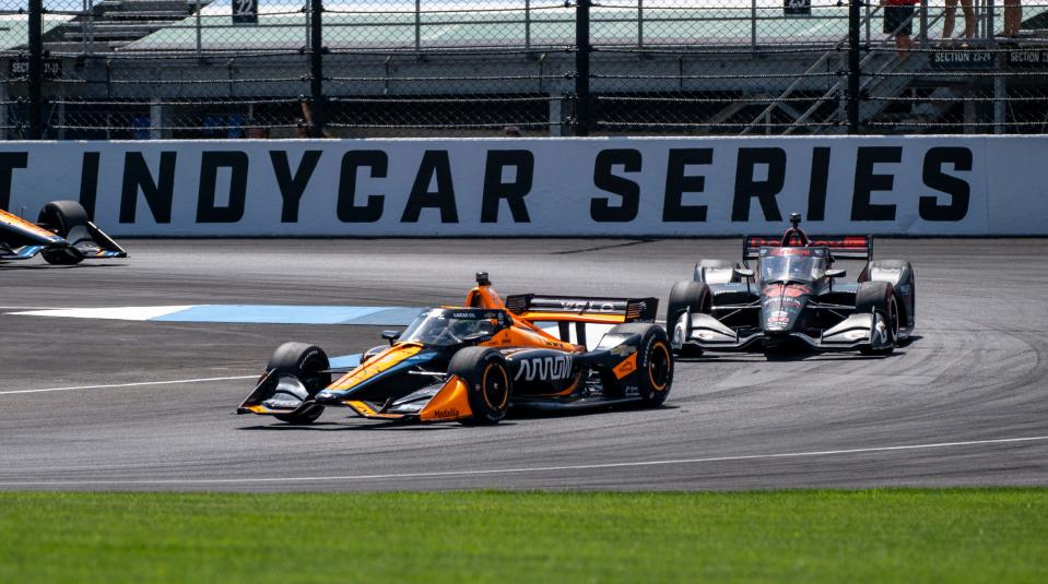 Arrow McLaren SP driver Pato O'Ward (5) leads Rahal Letterman Lanigan Racing driver Christian Lundgaard (45) through the first turn during the Gallagher Grand Prix at the Indianapolis Motor Speedway, Saturday, Aug. 12, 2023, in Speedway, Ind.