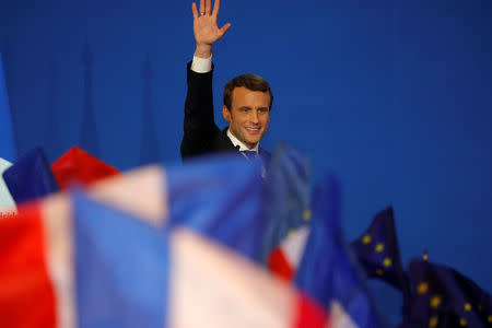 Emmanuel Macron, head of the political movement En Marche !, or Onwards !, and candidate for the 2017 French presidential election, waves to supporters after the first round of 2017 French presidential election at a polling station in Paris, France, April 23, 2017. REUTERS/Philippe Wojazer