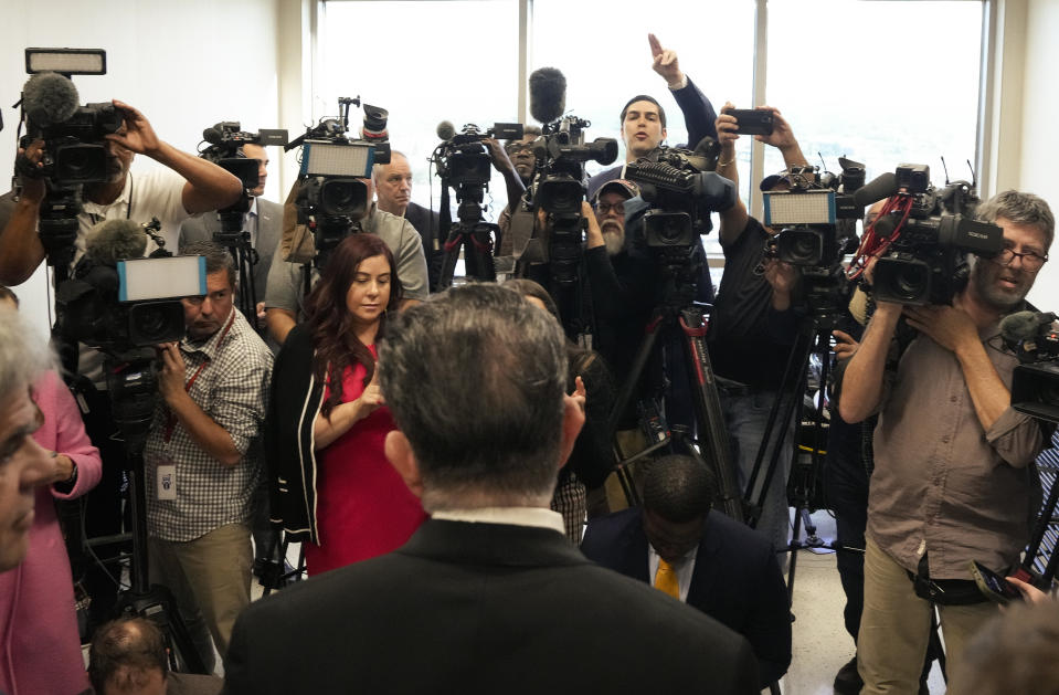 Reporters ask dfense attorney Dan Cordell, front, questions after Texas Attorney General Ken Paxton agreed to pre-trial diversion in his securities fraud case Tuesday, March 26, 2024 at Harris County Criminal Courts at Law in Houston. Paxton, on Tuesday, agreed to pay nearly $300,000 in restitution under a deal to end criminal securities fraud charges that have shadowed the Republican for nearly a decade. (Yi-Chin Lee/Houston Chronicle via AP)