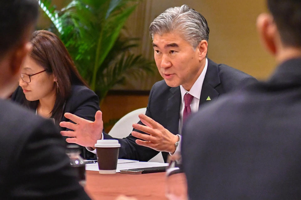 In this photo released by the U.S. State Department, U.S. Ambassador Sung Kim talks with members of the North Korean delegation during a working group meeting Monday, June 11, 2018 in Singapore one day before President Donald Trump will meet North Korean leader Kim Jong Un. (U.S. State Department via AP)