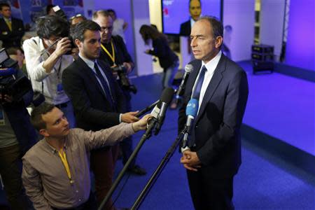 Jean-Francois Cope (R), France's centre-right UMP political party head, reacts to results after the polls closed in the European Parliament elections at their party headquarters in Paris, May 25, 2014. REUTERS/Charles Platiau