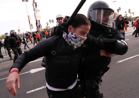 A police officer detains a demonstrator during a protest against Spain's cabinet meeting in Barcelona, Spain, December 21, 2018. REUTERS/Susana Vera