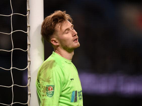 Goalkeeper Bradley Collins reacts after conceding a goal during Burton's heavy defeat (Getty)
