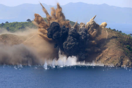 A target island off the coast of the Kalma International Airport in Wonsan, North Korea, is hit during a live-fire artillery drill August, 26 2017. KCNA/via REUTERS