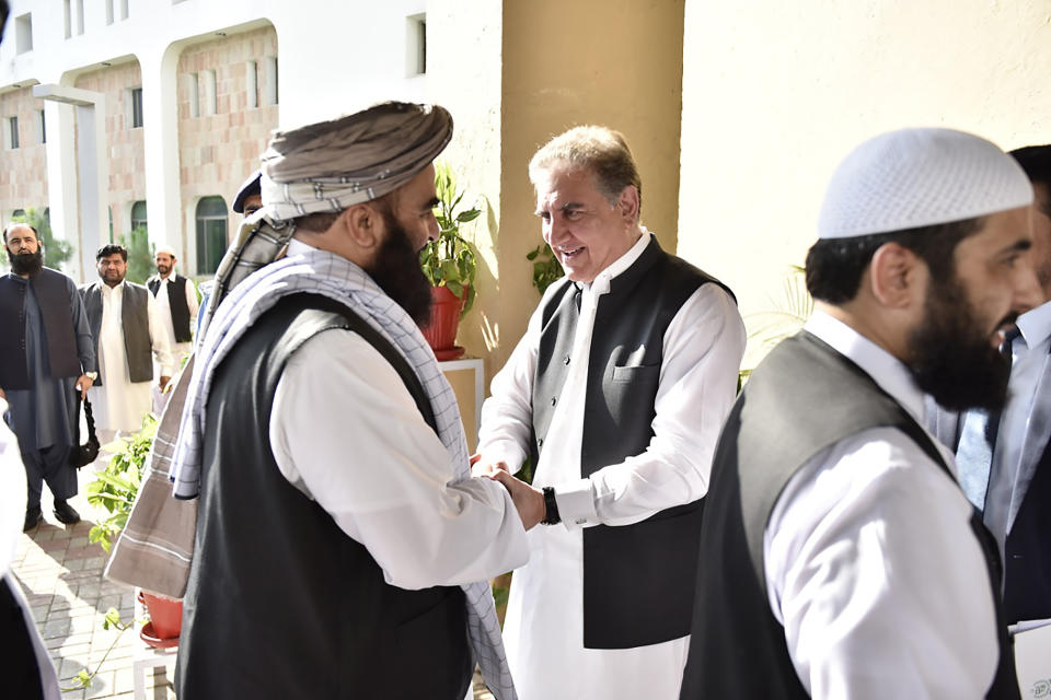 In this photo released by the Foreign Office, Pakistan's Foreign Minister Shah Mehmood Qureshi, center, receives members of Taliban delegation at the Foreign Office in Islamabad, Pakistan, Thursday, Oct. 3, 2019. Senior Taliban leaders are meeting with Qureshi in Islamabad as part of a push to revive an Afghanistan peace deal that has included stops in Russia, China and Iran. (Pakistan Foreign Office via AP)