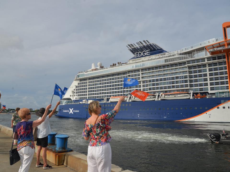 Crowds waving Port Everglades flags at the departing Celebrity Edge.