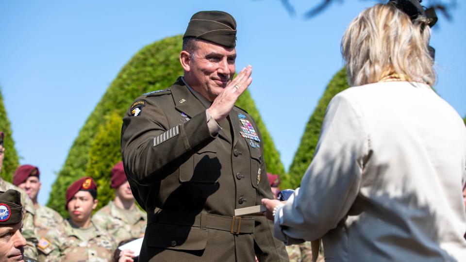 Gen. Andrew Poppas, commanding general, U.S. Army Forces Command, salutes a folded flag presented to him at the Eternal Heroes' Memorial Ceremony June 5, 2023 in Normandy, France. During the ceremony, Poppas presented veterans and veterans' family members with folded flags and coins. (Sgt. Erin Conway)