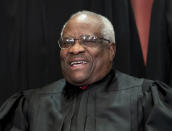 FIILE - In this Nov. 30, 2018, file photo, Supreme Court Associate Justice Clarence Thomas, appointed by President George H. W. Bush, sits with fellow Supreme Court justices for a group portrait at the Supreme Court Building in Washington. Thomas is now the longest-serving member of a court that has recently gotten more conservative, putting him in a unique and potentially powerful position, and he’s said he isn’t going away anytime soon. With President Donald Trump’s nominees Neil Gorsuch and Brett Kavanaugh now on the court, conservatives are firmly in control as the justices take on divisive issues such as abortion, gun control and LGBT rights. (AP Photo/J. Scott Applewhite, File)