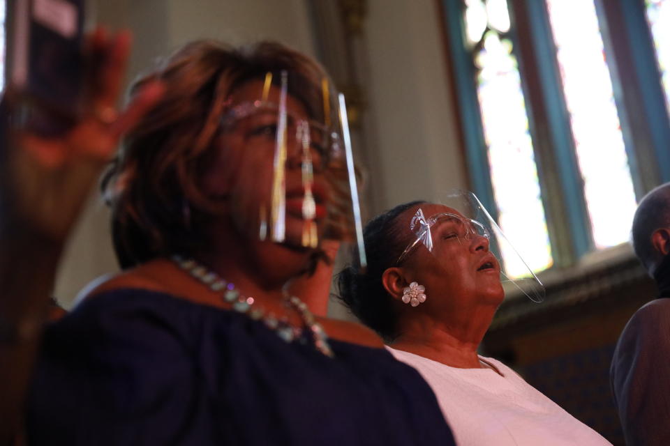 Parishioners attend mass as Rev. Michael Pfleger conducts his first Sunday church service as a senior pastor at St. Sabina Catholic Church following his reinstatement by Archdiocese of Chicago after decades-old sexual abuse allegations against minors, Sunday, June 6, 2021, in the Auburn Gresham neighborhood in Chicago. (AP Photo/Shafkat Anowar)