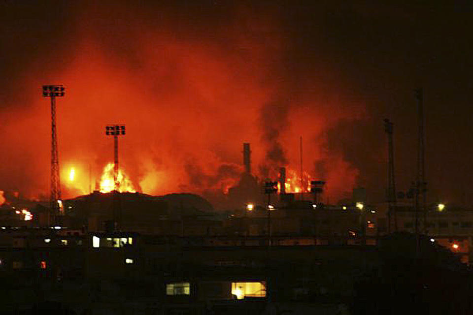 Fire rises over Amuay refinery near Punto Fijo, Venezuela, Saturday, Aug. 25, 2012. A huge explosion rocked Venezuela's biggest oil refinery, killing at least 19 people and injuring dozens, an official said. (AP Photo/Daniela Primera)