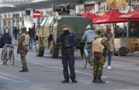 Belgian soldiers and police patrol in central Brussels as police searched the area during a continued high level of security following the recent deadly Paris attacks, Belgium, November 23, 2015. REUTERS/Yves Herman