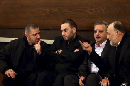 Hezbollah official Wafiq Safa (L) talks Hezbollah parliament member Ali Ammar (R) as Druze Democratic Party chief Talal Arslan (2nd R) looks on after offering their condolences to Bassam Qantar (2nd L), the brother of Lebanese Hezbollah militant leader Samir Qantar who was killed in an Israeli air strike in Damascus early on Sunday, in Beirut's southern suburbs, Lebanon December 20, 2015. REUTERS/Hasan Shaaban