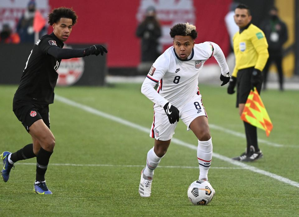 Weston McKennie, right, dribbles the ball away from Canada midfielder Tajon Buchanan during World Cup qualifying match on Jan. 30, 2022.