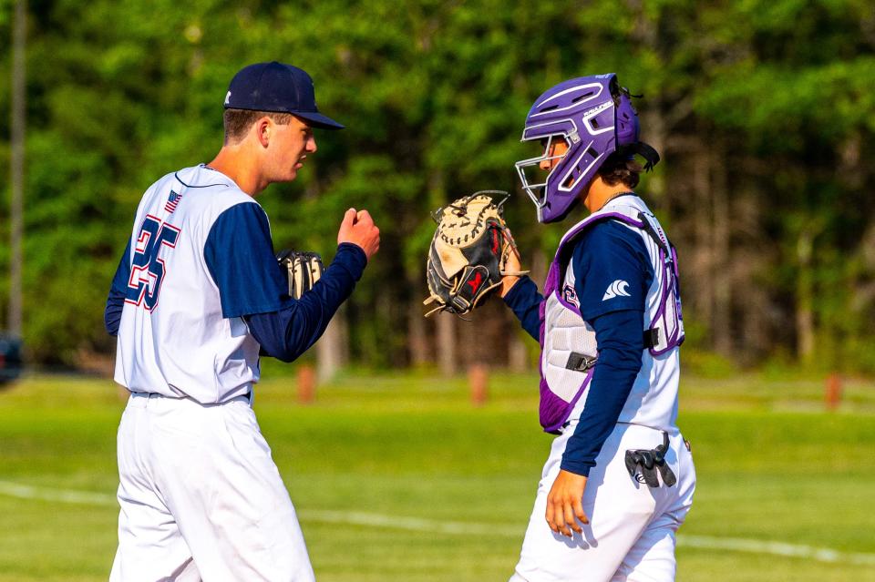 Apponequet's Nathan Levesque and Austyn Travis first bump at the start of the inning.