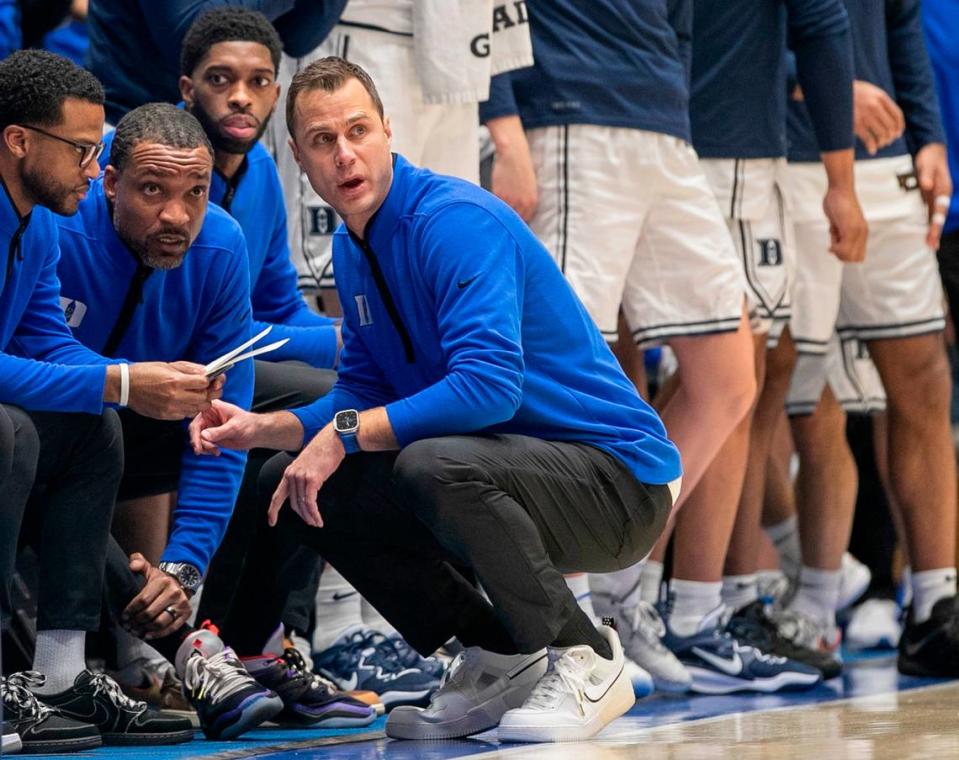 Duke coach Jon Scheyer huddles with his assistants, Jai Lucas, Chris Carrawell and Amile Jefferson in the second half against North Carolina on Saturday, February 4, 2023 at Cameron Indoor Stadium in Durham, N.C.