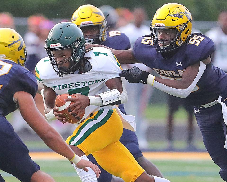 Firestone quarterback Daylyn Taylor is caught from behind by defensive lineman Steven Lasperance on Aug. 25 in Copley.