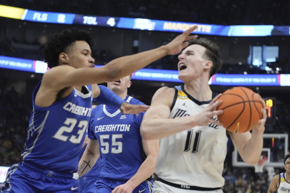 Marquette's Tyler Kolek tries to get past Creighton's Trey Alexander during the first half of an NCAA college basketball game Saturday, Dec. 30, 2023, in Milwaukee. (AP Photo/Morry Gash)