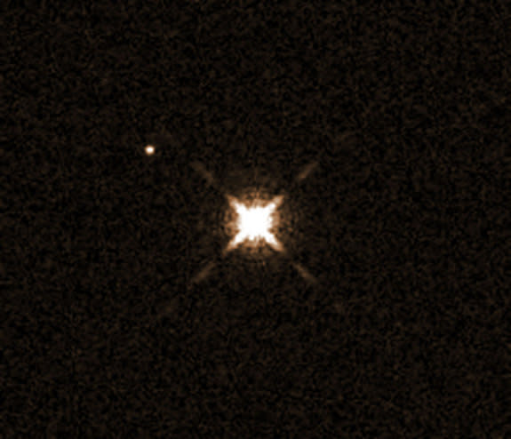 This image from the Hubble Space Telescope shows the star HAT-P-11 (center), which has a Neptune-size planet that is the smallest yet known to have water in its atmosphere. The planet, HAT-P-11b, is not visible in this image. The other bright o