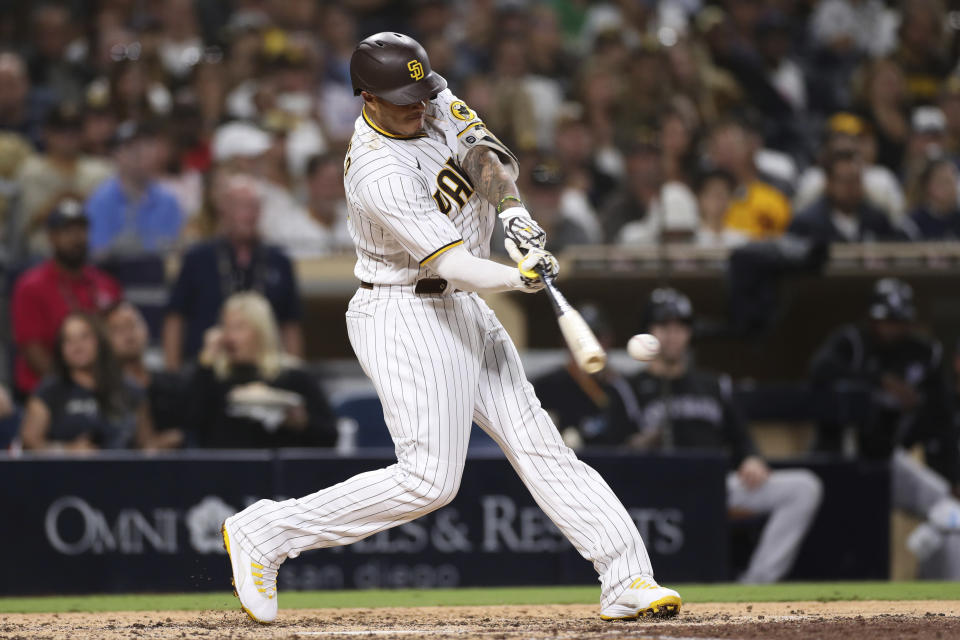 San Diego Padres' Manny Machado hits an RBI single during the seventh inning of the team's baseball game against the Colorado Rockies, Friday, July 9, 2021, in San Diego. AP Photo/Derrick Tuskan)