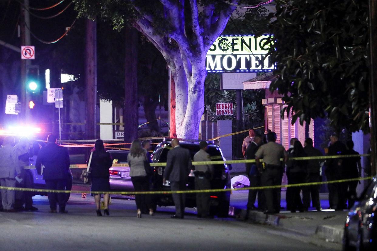 Law enforcement personnel investigate the scene after a shooting left two officers and a suspect dead Tuesday, June 14, 2022, in El Monte, California.