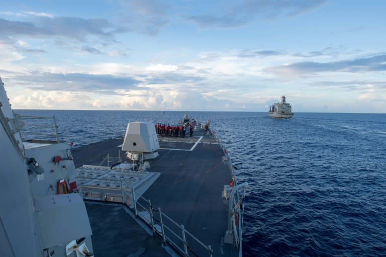 The guided-missile destroyer USS Dewey (L), which sailed near a reef claimed by Beijing in the South China Sea on May 25, 2017, an act denounced by China as a grave provocation