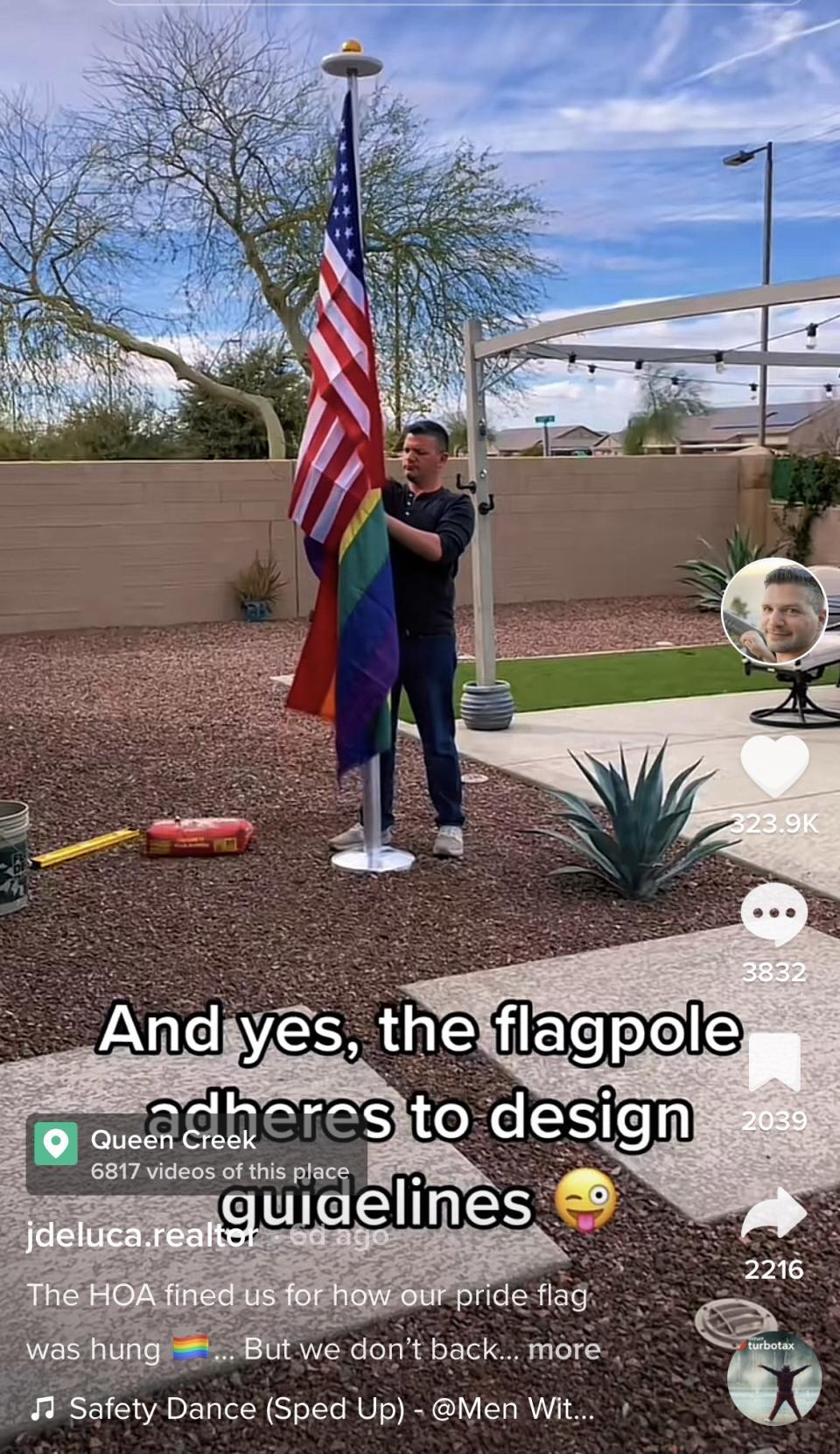 A man hanging a pride and US flag with the caption, "And yes, the flagpole adheres to design guidelines"
