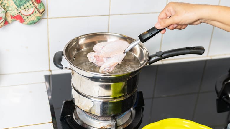 Raw chicken wings being boiled