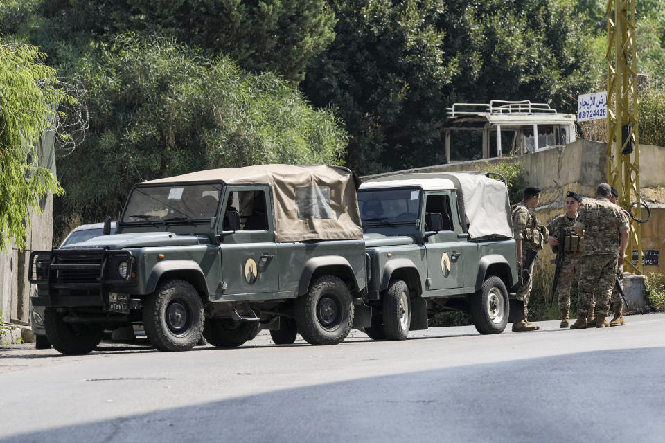 Lebanese security stand guard on a road that leads to the U.S. Embassy in Aukar, a northern suburb of Beirut, Lebanon, Wednesday, June 5, 2024. A gunman was captured by Lebanese soldiers after attempting to attack the U.S. Embassy near Beirut on Wednesday, the military said. (AP Photo/Bilal Hussein)