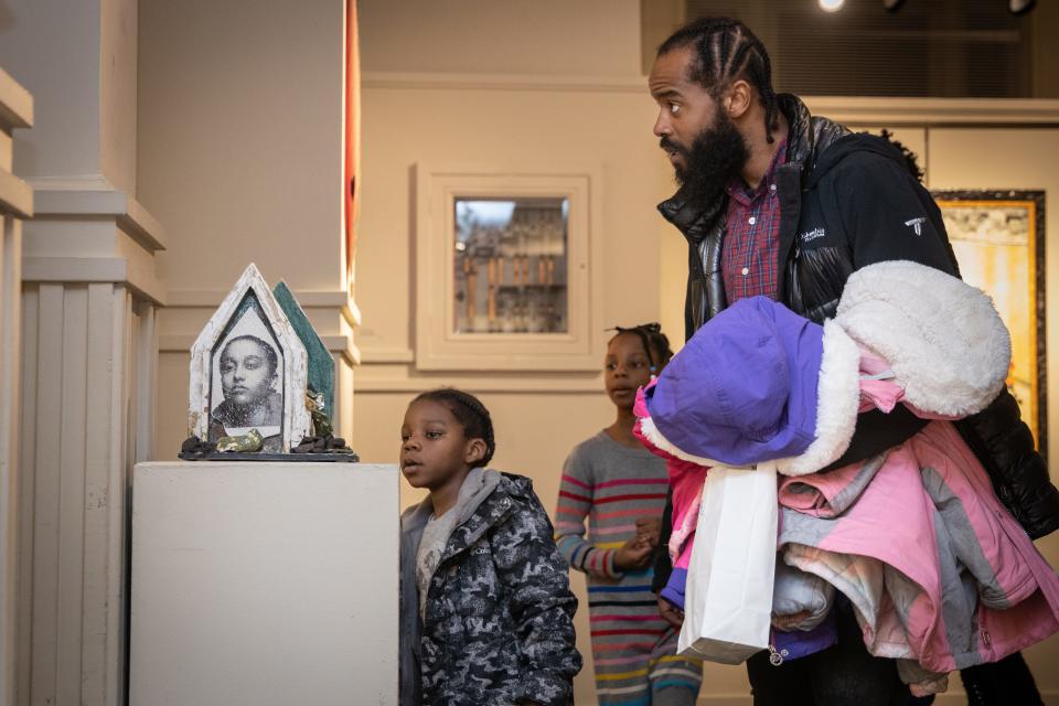Emmanuel Reynolds, his sister, Mariah, and his father, Jamal Reynolds, examine a sculpture during a reception on Thursday, Jan. 26, 2023, at The Arts Council of Fayetteville/Cumberland County. Mariah is one of The Fayetteville Observer's 2023 Future Black History Makers.