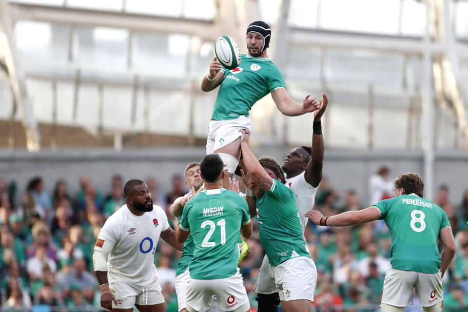 Ireland's Ross Byrne, top, catches the off a line out throw during the international rugby union match between Ireland and England, at Aviva Stadium, Dublin, Ireland, Saturday, Aug. 19, 2023. (AP Photo/Peter Morrison)