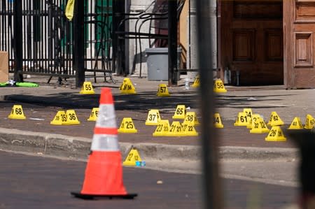 Evidence markers rest on the ground after a mass shooting in Dayton