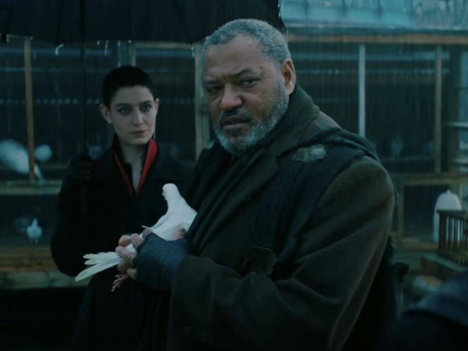 Asia Kate Dillon as the Adjudicator confronting Laurence Fishburne as the Bowery King.