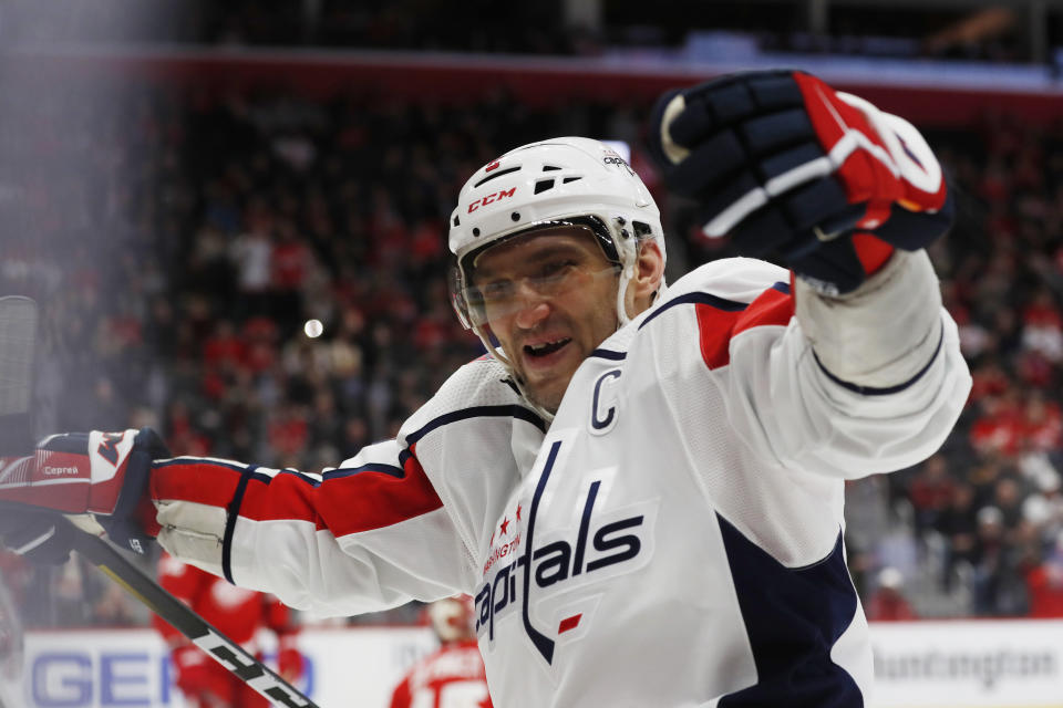 Washington Capitals left wing Alex Ovechkin celebrates the goal of right wing Tom Wilson during the third period of the team's NHL hockey game against the Detroit Red Wings, Saturday, Nov. 30, 2019, in Detroit. (AP Photo/Carlos Osorio)