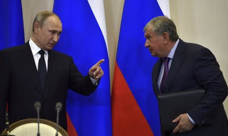 FILE PHOTO: Russian President Putin gestures as he talks with Rosneft CEO Igor Sechin during signing ceremony following meeting with Italian PM Paolo Gentiloni at Bocharov Ruchei state residence in Sochi