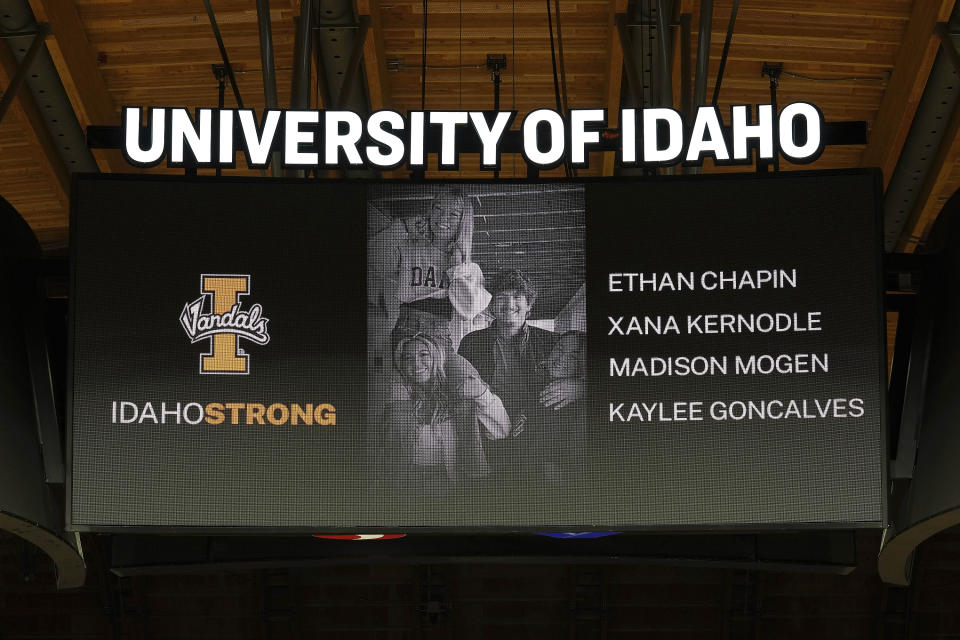 FILE - A photo and the names of four University of Idaho students who were killed over the weekend at a residence near campus are displayed during a moment of silence, Nov. 16, 2022, before an NCAA college basketball game in Moscow, Idaho. Investigators have yet to name a suspect in the stabbing deaths of four University of Idaho students who were found dead in a home near campus last month. But would-be armchair detectives and internet sleuths have come up with several of their own, the conclusions often based on conjecture and rumor. (AP Photo/Ted S. Warren, File)