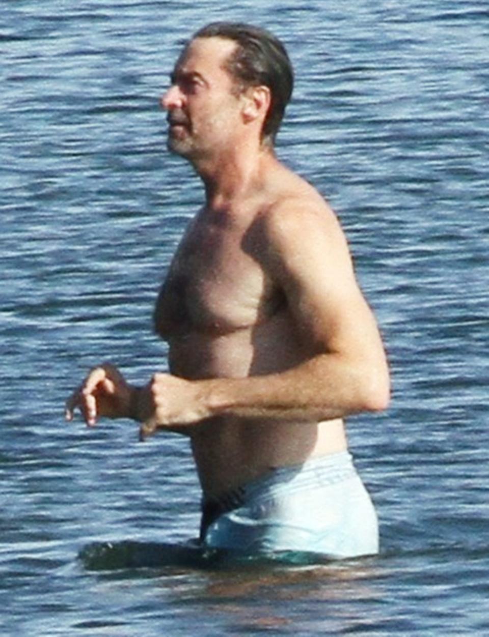 <p>Hugh Jackman goes for a swim on Monday in The Hamptons, New York, to cool off from the heat.</p>