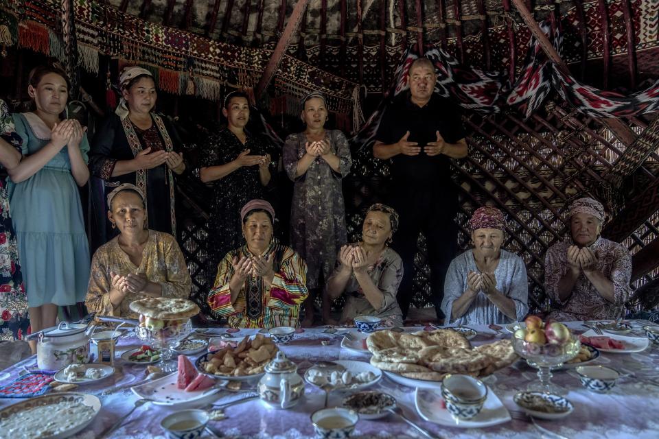 Residents of Shege village pray for the revival of the Aral Sea near Muynak, Uzbekistan, Wednesday, July 12, 2023. (AP Photo/Ebrahim Noroozi)